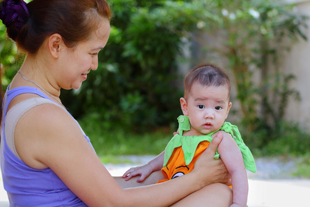 Mother holding her baby,close upの写真素材