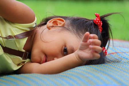 Little asian girl was playing happily in the parkの写真素材