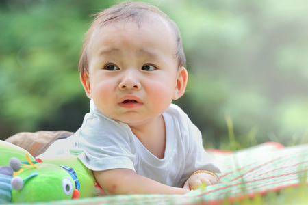 asian baby was playing happily in the park