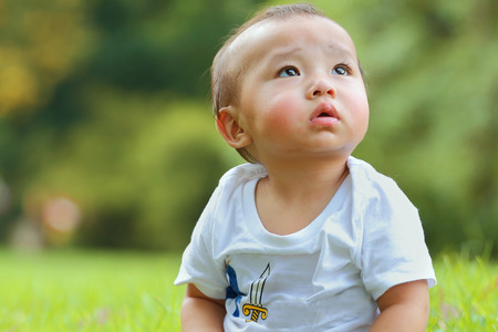 asian baby was playing happily in the parkの写真素材