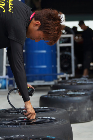 Buriram THAILAND - October 5:Car mechanic in uniform. Auto repair in the Super GT race car 2014 at Chang International Circuit in Buriram United, on October 4-5, 2014 at the Buriram, Thailand.のeditorial素材