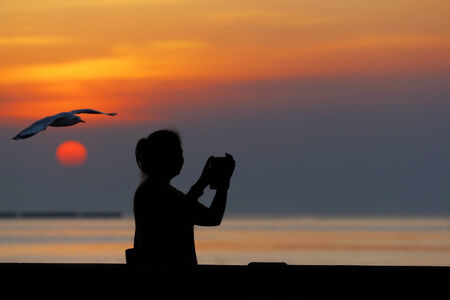 Asian man standing at the sea, silhouetteの写真素材