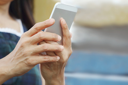 Hand are holding mobile phone,solf focusの写真素材