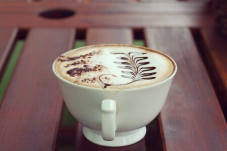 Mocha in white coffee cup in the Coffee Shop, Blurred background and soft focusの写真素材