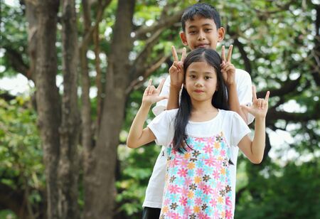 Portrait, asian children in the park and look at cameraの写真素材