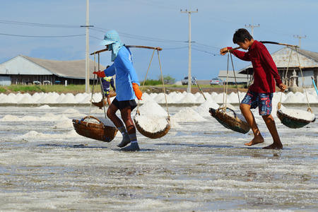Phetchaburi, Thailand - March 2: Agriculture in Thailand, Workers working in the salt farm in Phetchaburi, Thailand on May 22, 2015.のeditorial素材