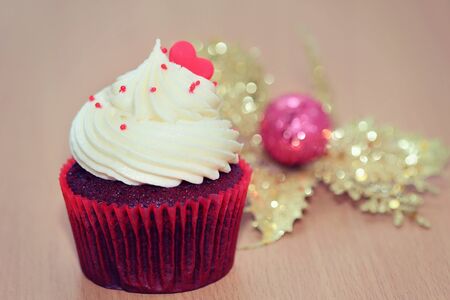 Closeup, cupcake and whipped cream on the tableの写真素材