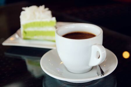 Hot coffee cup and cake on the table, vintage toneの写真素材