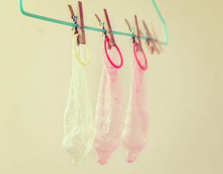 Clothespin and a condom. Recycling concept humor, vintage toneの写真素材