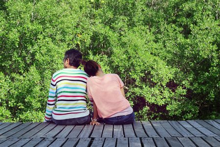 Two lovers sitting on the bridge at the Mangrove forest.の写真素材
