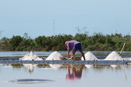 Phetchaburi, Thailand - September 9, 2015: Agriculture in Thailand, Workers working in the salt farm in Phetchaburi, Thailand.のeditorial素材