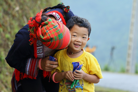 Ha Giang, Vietnam - September 17, 2015: Hmong family in Vietnam, Mother kiss her son. In the northern province of Ha Giang in Vietnam. An area adjacent to China.のeditorial素材