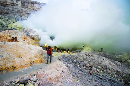 Java, Indonesia - April 4, 2016: The workers were carrying sulfur ore in Kawah Ijen Vacano. The Ijen volcano complex is a group of stratovolcanoes in the Banyuwangi Regency of East Java, Indonesia.のeditorial素材