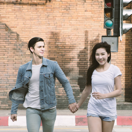 Young couple in love, Couple running across the crosswalkの写真素材