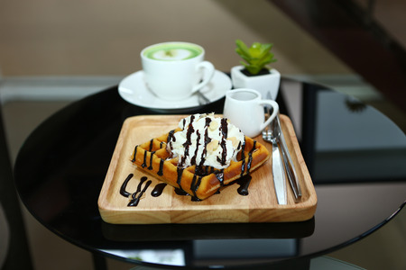 waffle and whipped cream with chocolate sauceの写真素材