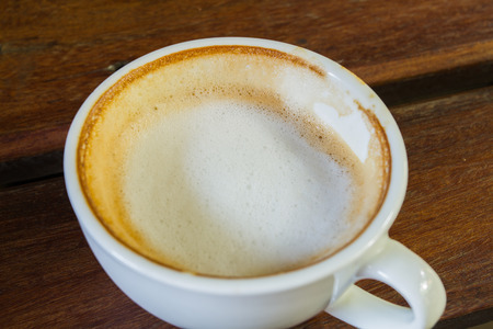 White coffee cup on wooden tableの写真素材