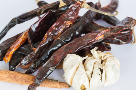 Garlic red dry chili and various types of black pepper on wood backgroundの写真素材