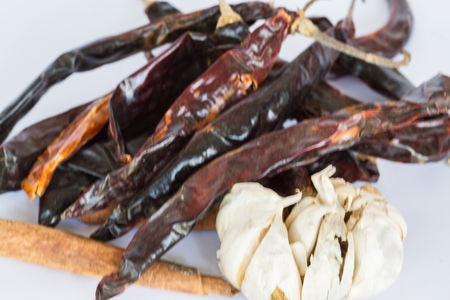 Garlic red dry chili and various types of black pepper onwhite backgroundの写真素材