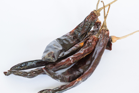 red chillies with red chilly powder on white backgroundの写真素材