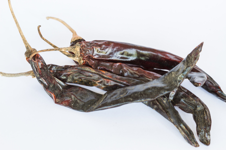 red chillies with red chilly powder on white backgroundの写真素材