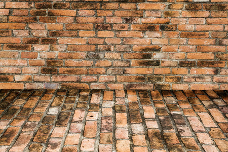 grunge background, red brick wall texture bright plaster wall and blocks road sidewalk abandoned exterior urban background for your concept or projectの写真素材