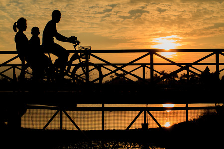 silhouette of biker on Bridge at sunsetの写真素材