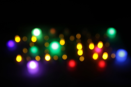 Abstract circular bokeh background of candlelight and Christmaslight on dark nightの写真素材