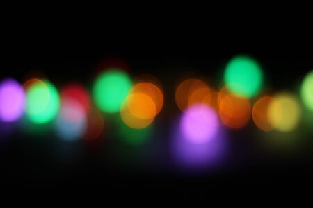 Abstract circular bokeh background of candlelight and Christmaslight on dark nightの写真素材