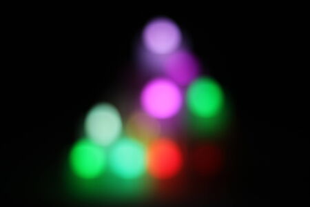 Abstract circular bokeh background of candlelight and Christmaslight on dark nightの写真素材