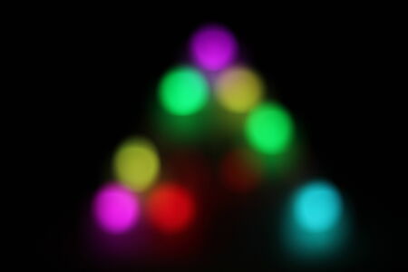 Abstract circular bokeh background of candlelight and Christmaslight on dark nightの写真素材