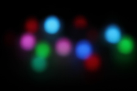 Abstract circular bokeh background of candlelight and Christmaslight on dark nightの写真素材