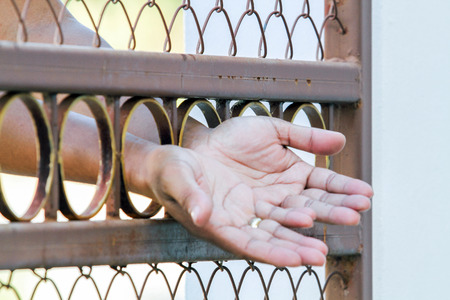 Man behind jail barsの写真素材
