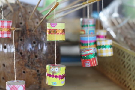 This thai retro toy calling \" Jak ka jan \" because when swing it. Sound like a cicada bug. It make from bamboo,clay, small rope and color paper.の写真素材
