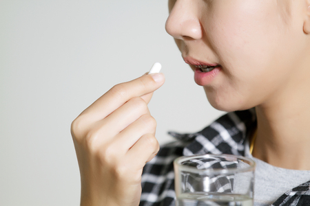 Asian women are taking medicines and vitamins for help Sick and healthyの写真素材