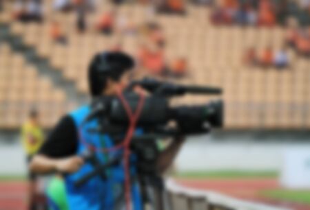 blurry of Professional cameraman and Video camera operator working with his professional equipmentの写真素材