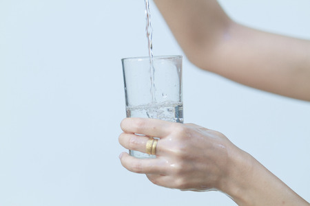 Portrait of young beautiful woman asia drinking water at summer and holding bottle