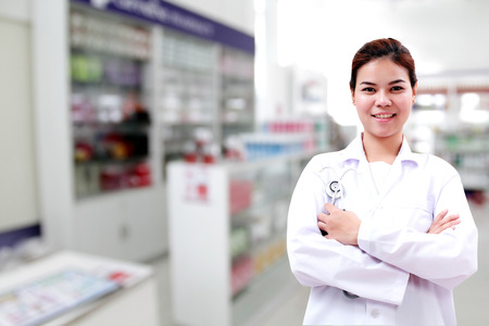 pharmacist chemist and medical doctor woman asia with stethoscope and clipboard checking medicine cabinet and pharmacy drugstoreの写真素材