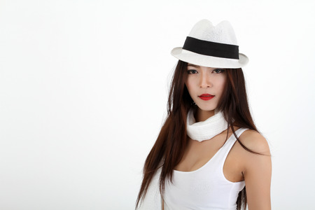 Winter Beauty Woman asia Fashion Girl Concept. Skin and hair care in cold season. Beautiful woman with long hair wearing a sweater, scarf, hat and gloves. Holiday Fashion Portrait.on white backgroundの写真素材