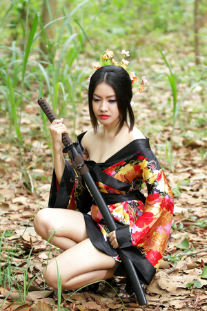 portrait Asia Beautiful Japanese kimono woman and Japanese geisha woman with Japanese sword and Woman with japan sword katana in handsの写真素材