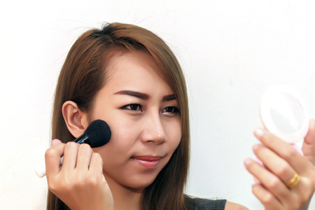 closeup women asia Makeup Applying  Cosmetic Powder Brush. Perfect Skinの写真素材