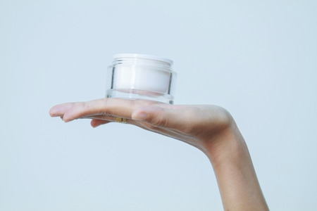 A beautiful woman asia using a skin care product, moisturizer or lotion and Skincare  taking care of...