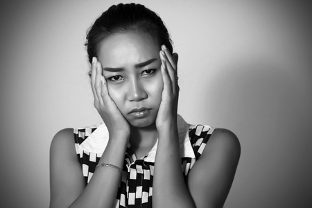 Asian women There are many have a headache and  toothache after orthodontics on white background.の写真素材