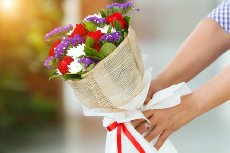 Blurry of Woman holding a bouquet of roses in hand for Valentine's Dayの写真素材