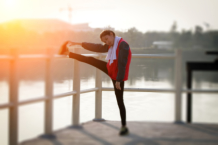 blurry of Athletic woman asia warming up and Young female athlete sitting on an exercising and...