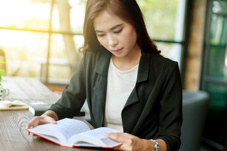Asian woman reading a book for relaxation ,soft focusの写真素材