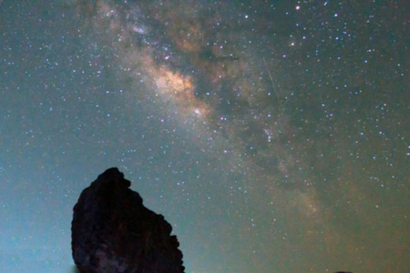 blurry and Long exposure photograph with gain of the Milky Way galaxy on dark night at thailandの写真素材