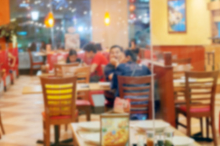 Blur of People enjoy eating and talking in a restaurant.の写真素材