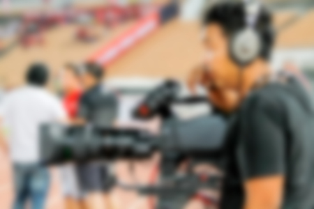 blurry of Professional cameraman and Video camera operator working with his professional equipmentの写真素材