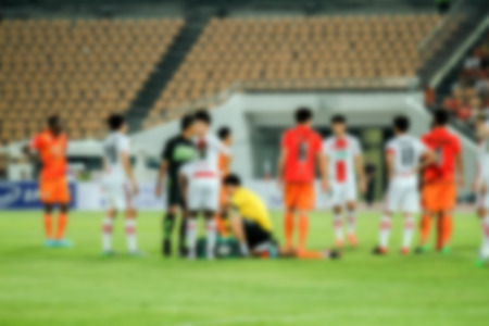 blurry Doctors and referee with injured player at the football matchの写真素材