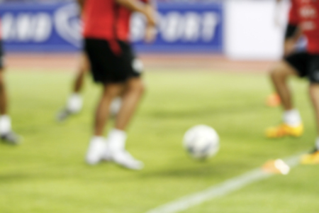 blurry soccer and football player training for backgroundの写真素材